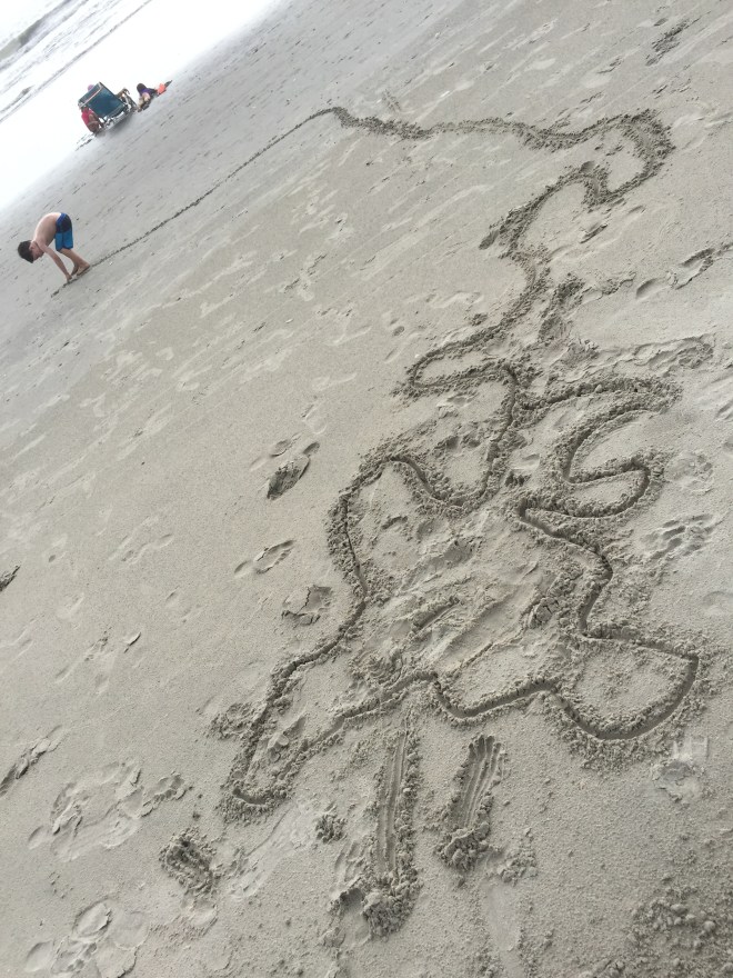 Ollie working on his twisty maze in the sand